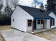 White house with blue accents and a new concrete driveway at 123 Oak St, Chester, SC 29706