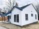 Side view of a charming white house with blue accents at 123 Oak St, Chester, SC 29706