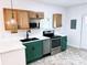 Modern kitchen with green cabinets, marble countertops, and stainless steel appliances at 123 Oak St, Chester, SC 29706