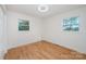 Spacious bedroom featuring two windows and light wood floors at 129 Doster Rd, Lancaster, SC 29720