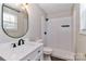 Modern bathroom with a tiled shower, sleek vanity, and modern light fixtures at 161 Westscott Dr, Statesville, NC 28625