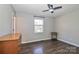 Serene bedroom featuring a ceiling fan, hardwood floors, natural light, and minimalistic decor at 161 Westscott Dr, Statesville, NC 28625