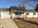 Charming single-story home with a cozy front porch, attached garage and well-maintained lawn at 161 Westscott Dr, Statesville, NC 28625