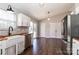 Bright kitchen with stainless steel fridge, white farmhouse sink, butcher block counters and sliding door to backyard at 161 Westscott Dr, Statesville, NC 28625