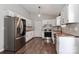 Updated kitchen boasts white cabinetry, wooden countertops, stainless steel appliances, and stylish backsplash at 161 Westscott Dr, Statesville, NC 28625