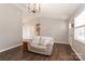 Bright living room with vaulted ceilings and wood-look flooring, illuminated by a modern chandelier at 161 Westscott Dr, Statesville, NC 28625