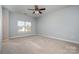 Spacious bedroom with neutral carpeting and large window at 18107 Amberwood Glen Dr, Cornelius, NC 28031