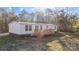 White mobile home with a wooden deck and large backyard at 2029 Big Dipper Dr, Clover, SC 29710