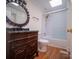 Traditional bathroom features wood vanity, decorative mirror, and glass shower door at 317 Belwood Dr, Belmont, NC 28012