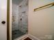 Bathroom features glass enclosed shower with decorative tile work and modern gold fixtures at 317 Belwood Dr, Belmont, NC 28012