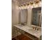 Bright bathroom features double vanity with marble countertop, stylish mirrors and lighting at 317 Belwood Dr, Belmont, NC 28012