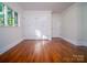 Bright bedroom features hardwood floors, a window, and double closet doors at 317 Belwood Dr, Belmont, NC 28012