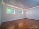 Bright bedroom features hardwood floors, a decorative ceiling, and double closet doors at 317 Belwood Dr, Belmont, NC 28012