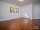 Bright bedroom with hardwood floors, a large window and double closet doors at 317 Belwood Dr, Belmont, NC 28012