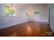 Bedroom with hardwood floors, bright light fixtures, and large windows with a view to the outside at 317 Belwood Dr, Belmont, NC 28012