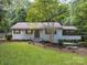 Attractive single-story home with landscaped yard, shutters, and a screened porch addition on the side at 317 Belwood Dr, Belmont, NC 28012