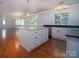 Open-concept kitchen featuring an island, wood floors, and modern appliances at 317 Belwood Dr, Belmont, NC 28012