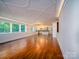 Open-concept living room with hardwood floors leading to kitchen area with custom ceiling at 317 Belwood Dr, Belmont, NC 28012