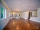 Living room with hardwood floors seamlessly connects to the kitchen and offers ample storage at 317 Belwood Dr, Belmont, NC 28012