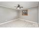 Cozy bedroom featuring tile flooring and neutral walls, illuminated by a ceiling fan and natural light at 4556 Harley Davidson Dr, Catawba, NC 28609