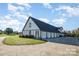 Sprawling house featuring a six-car garage and an attached porch with well manicured lawn and concrete driveway at 4556 Harley Davidson Dr, Catawba, NC 28609