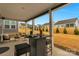 Covered patio with seating area, overlooking a landscaped backyard and neighboring homes at 7014 Jolly Brook Dr, Charlotte, NC 28215