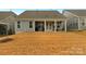 House with covered patio and grassy backyard at 7014 Jolly Brook Dr, Charlotte, NC 28215