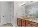 Double vanity bathroom with granite countertops and large mirror at 7014 Jolly Brook Dr, Charlotte, NC 28215