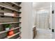 Small bathroom with shower/tub combo and built-in shelving at 7014 Jolly Brook Dr, Charlotte, NC 28215