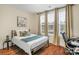 Cozy bedroom with a bed, desk, and ample natural light at 7014 Jolly Brook Dr, Charlotte, NC 28215