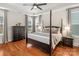 Main bedroom with hardwood floors, large bed, and plenty of light at 7014 Jolly Brook Dr, Charlotte, NC 28215