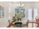 Bright dining area with glass table and wicker chairs near kitchen at 7014 Jolly Brook Dr, Charlotte, NC 28215