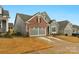 Two-story home with gray siding, brick accents, and a two-car garage at 7014 Jolly Brook Dr, Charlotte, NC 28215