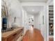 Bright hallway with hardwood floors and built-in shelving at 7014 Jolly Brook Dr, Charlotte, NC 28215