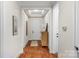 Light-filled hallway featuring hardwood floors and access to rooms at 7014 Jolly Brook Dr, Charlotte, NC 28215