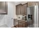 Kitchen features gray cabinets, granite countertops, and built in coffee maker at 7014 Jolly Brook Dr, Charlotte, NC 28215