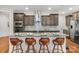 Granite kitchen island with seating for four and stainless steel appliances at 7014 Jolly Brook Dr, Charlotte, NC 28215