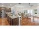 Open concept kitchen and living area with hardwood floors and island at 7014 Jolly Brook Dr, Charlotte, NC 28215