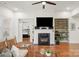 Living room with fireplace, built-in shelving, and view into bedroom at 7014 Jolly Brook Dr, Charlotte, NC 28215