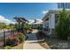 Walkway beside pool with pergola and clubhouse view at 7014 Jolly Brook Dr, Charlotte, NC 28215