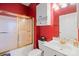 Compact bathroom featuring white fixtures, cabinet storage, and tiled shower at 8931 Meadow Vista Rd, Charlotte, NC 28213