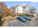 Exterior shot of building with covered balconies and ample parking at 8931 Meadow Vista Rd, Charlotte, NC 28213