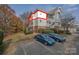 Exterior shot of building with covered balconies and ample parking at 8931 Meadow Vista Rd, Charlotte, NC 28213