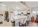 Well-lit kitchen featuring white cabinetry, modern appliances, and a convenient breakfast bar at 8931 Meadow Vista Rd, Charlotte, NC 28213