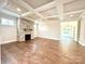 Living room featuring a stone fireplace, coffered ceiling, and hardwood floors at 959 Tamary Way # 29/30, Landis, NC 28088