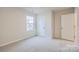 Bright bedroom with gray carpeting and a large window at 108 Mountain Bridge Way, Statesville, NC 28625