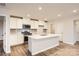 Modern kitchen with white cabinets, quartz countertops, and stainless steel appliances at 108 Mountain Bridge Way, Statesville, NC 28625