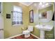 Charming bathroom with pedestal sink, toilet, and decorative artwork at 124 Harris Farm Rd, Mooresville, NC 28115