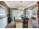 Modern dining room with a built-in bench and large windows at 124 Harris Farm Rd, Mooresville, NC 28115