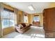 Relaxing sunroom with a leather couch and ample natural light at 124 Harris Farm Rd, Mooresville, NC 28115